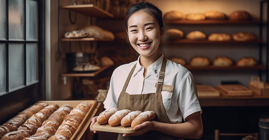 Woman smiling and carrying bread